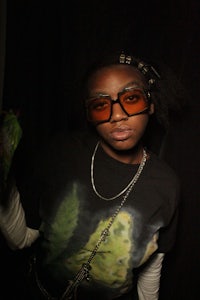 a woman wearing glasses and a t shirt