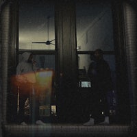 two people standing in front of a door